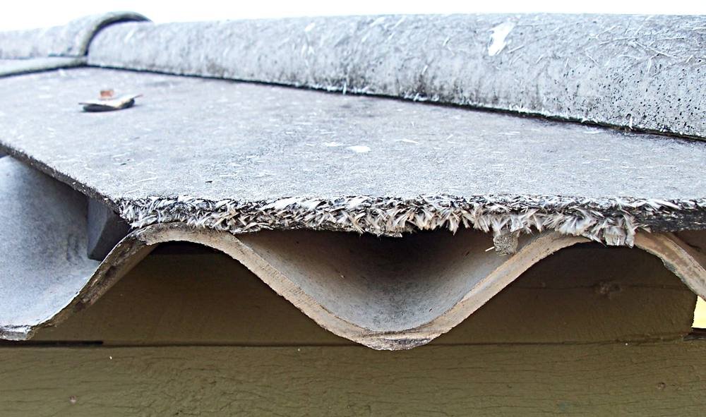 Weathered asbestos cement roof sheets on a building
